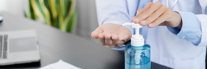 Doctor Wearing Medical Mask with hand sanitizer gel for hand hygiene corona virus protection  healthcare worker
