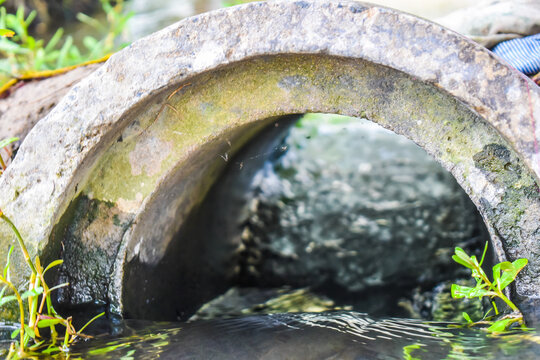 Water Is Flowing Through A Pipe In Agriculture Land. Wildlife Background.