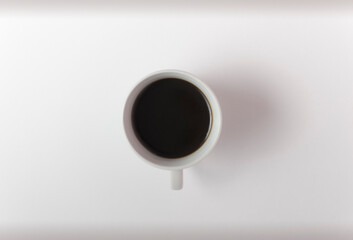 cup of coffee on a white background top view