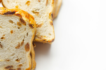 Fruit loaf with sultanas and orange flavored pieces on the white background