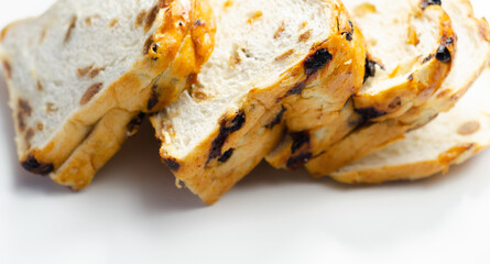 Fruit loaf with sultanas and orange flavored pieces on the white background