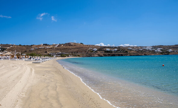 Sandy beach, ocean sea water touches wet sand, summer vacations concept