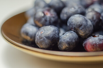 Closeup on fresh and ripe blueberries on a white background