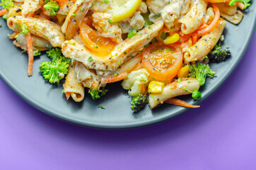 Piri piri style chicken on a bed of wholewheat pasta and vegetables, with a cool sour cream and chive dressing