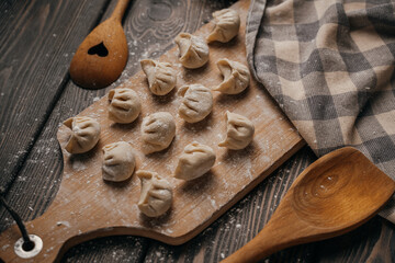 Frozen, beautifully sculpted dumplings laid out on a cutting board