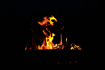 flames at night. Fire flames on black background.  tongues of flame on the background of coals
