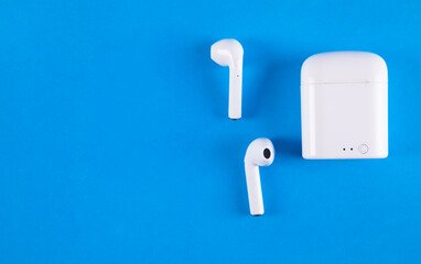 Wireless headphones on a blue background.