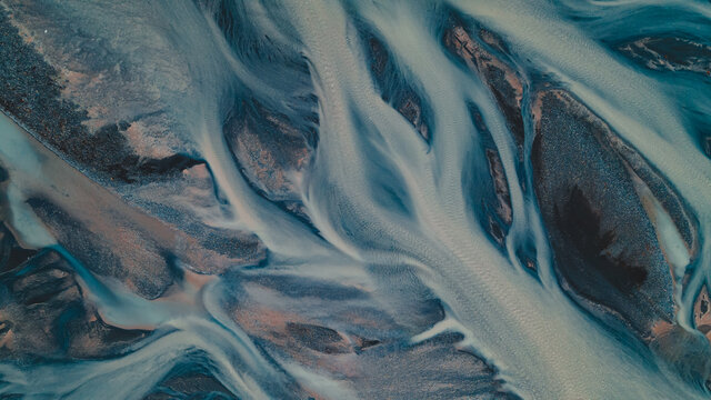 A glacial rivers from above. Aerial photograph of the river streams from Icelandic glaciers. Beautiful art of the Mother nature created in Iceland. Wallpaper background high quality photo