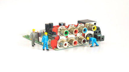 Worker figure on circuit board,service concept.