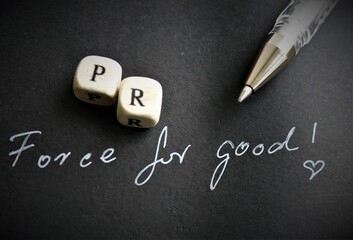 Public relations force for good letters on dark background