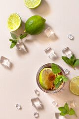 Cuba Libre alcoholic drink, Cola with ice cubes or lemonade on a pastel brown background. Top view...