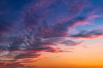 Colorful and vibrant cloudscape view of majestic sky at sunset or sunrise. Dramatic and idyllic background