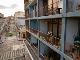 
Girl watching empty streets of Guatemala city because of quarantine of coronavirus, covid-19.
