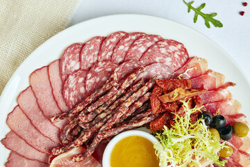 plate with sausage cuts on a light background