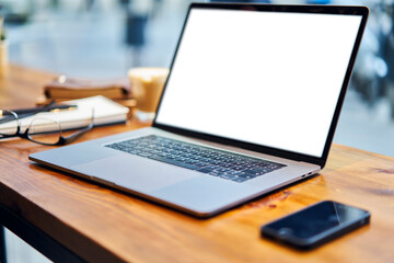 Workplace with laptop and smartphone on table