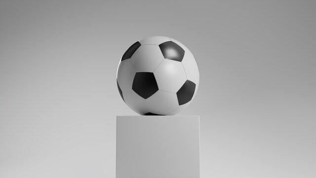 Black and White Football on a plinth against a White Background.