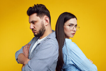 Displeased couple with arms folded, have fight, stand back to back 