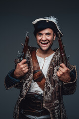 Fototapeta premium Studio shot of crazy pirate with boarding pistols