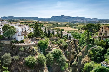 Photo sur Plexiglas Ronda Pont Neuf a landscape view of the hills and valleys surrounding the magical mountain town of Ronda in southern Spain