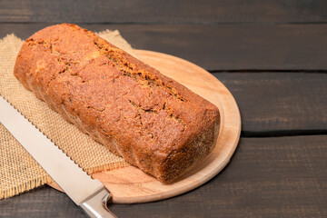 Rye bread on dark wooden table with copy space