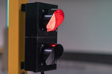 Traffic lights closeup turn red when entering or exiting parking lot. Road safety.