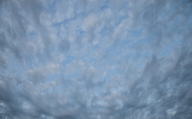 gloomy gray clouds in a blue sky