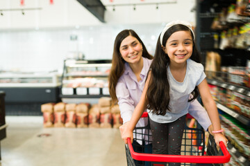 Portrait of a pretty child with her mom at the store