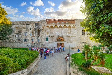 Tourists gather in tour groups outside the ancient Golden Gate to the Diocletian's Palace section...