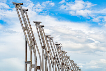 Workers are repairing a noise barrier by a road. Renovation work in a residential area.