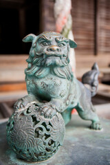 Fototapeta na wymiar Bronze sculpture of a lion, commonly used in Buddhist temples.