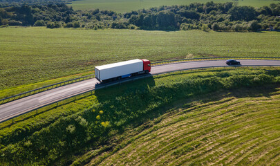 Truck with Cargo Semi Trailer Moving on Rural Road in Direction. Aerial Top View