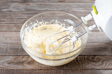 Butter in a glass bowl with a mixer