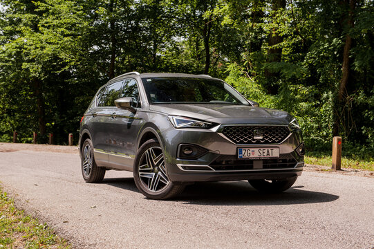 New Seat Tarraco in grey colour on the road in forest. New Seat SUV luxury vehicle