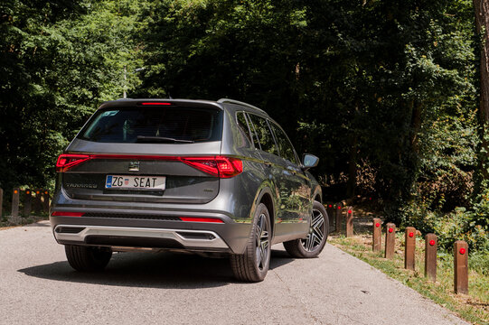 New Seat Tarraco in grey colour on the road in forest. New Seat SUV luxury vehicle.