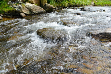 River water rushing over rocks in the rapids