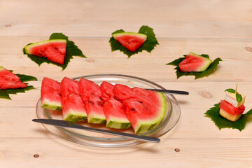 slices of watermelon and original serving on the leaves