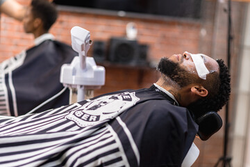 cleansing skin in latin hairdressing salon, to open pores for a better shave.with razor and hair clipper. .