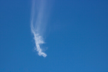 Blue, beautiful sky background. Oddly shaped clouds in a blue sky