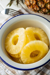 Canned sliced pineapple fruit in bowl