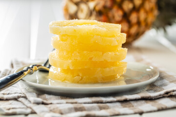 Canned sliced pineapple fruit on plate.