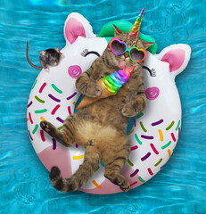 A beige cat unicorn in sunglasses with a cone of ice cream is lying on an inflatable white ring in a swimming pool at the resort.