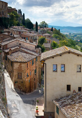 Fototapeta na wymiar Houses and empty street at Montepulciano medieval hill town. Tuscany Italy, Europe