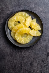 Canned sliced pineapple fruit on plate