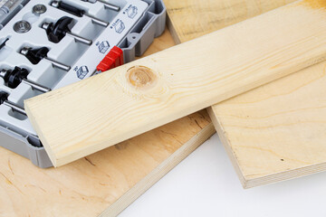 Mills exposed in a row on a wooden background. Milling cutter and router bit. Carbide drill or milling cutter.