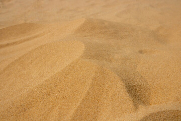 Fototapeta na wymiar Sand mounds on the beach.Desert Dunes. closeup of sand pattern of a beach in the summer