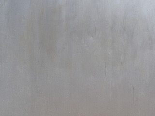 The texture of unevenly applied gray paint on an iron wall with rust spots and scratches....