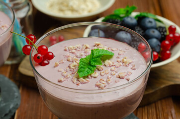 Fresh and healthy berry smoothie with muesli flakes 
