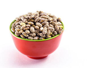 small portion of brazilian beans on isolated white background, pot with raw bean seeds, isolated on white background.