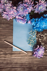 Violet, blue and pink chrysanthemum. A bouquet of chrysanthemums on wooden background with copy space. Chrysanthemum Flower Close up.