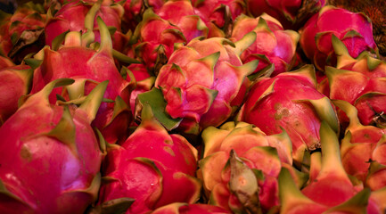 Fresh white dragon fruit with bright pink and red colors at local farmers market.